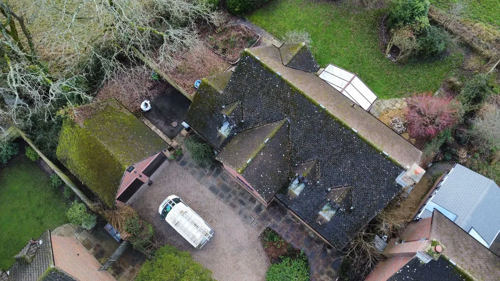 Tiled roof with a conservatory before work
