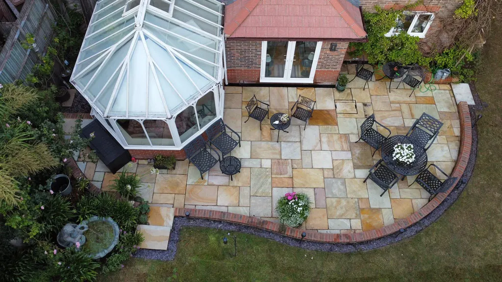 Patio beside a conservatory after work