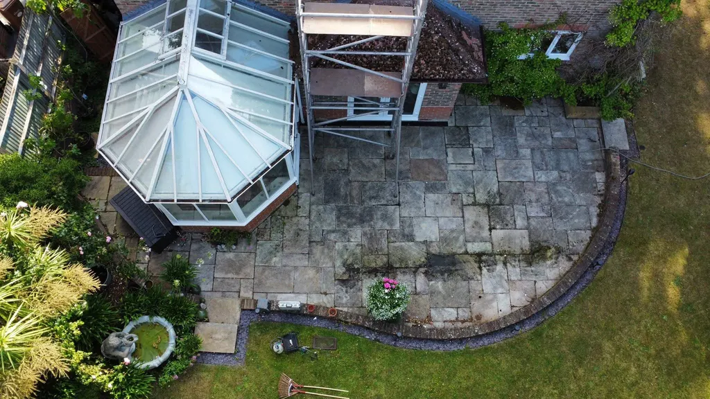 Patio beside a conservatory before work